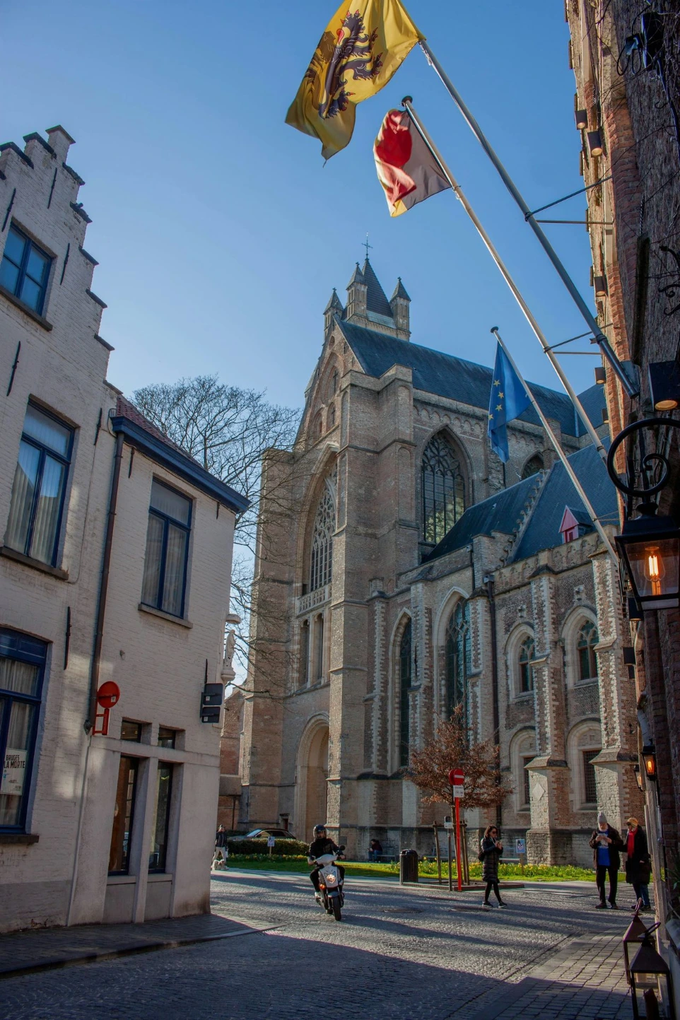 A european street scene with church and flags.