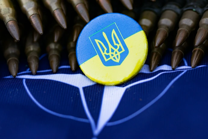 a blue and yellow button sitting on top of a table