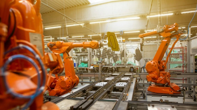 a factory filled with lots of orange machines