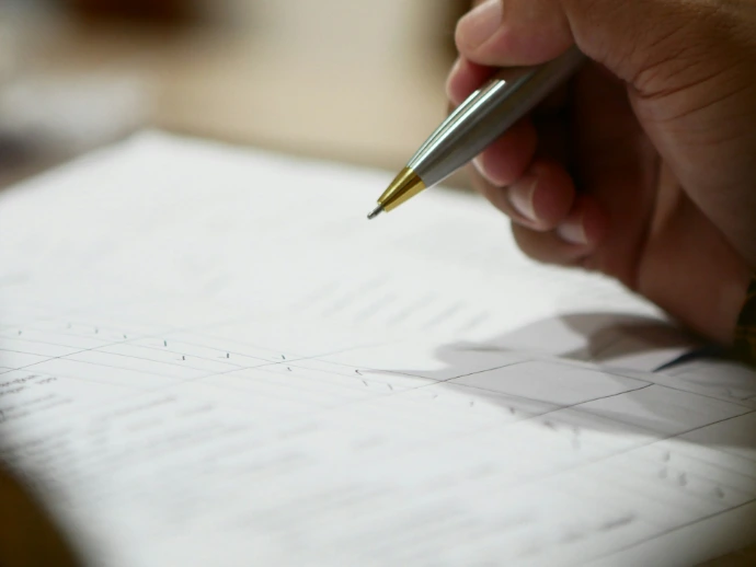 a hand holding a pen