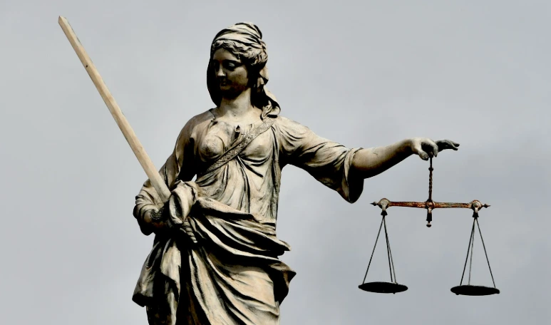 A statue of lady justice holding a sword and a scale